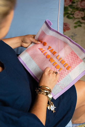 A needle pointed practices basic needlepoint stitches on a hand-painted needlepoint canvas.