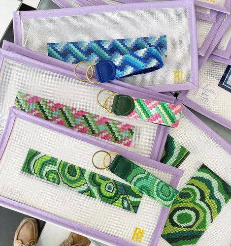 Decorative needlepoint stitches show intricate details on needlepoint keychains.