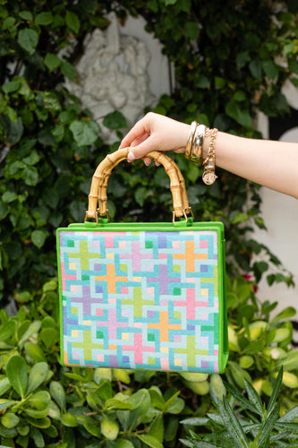 Lycette Designs displays a custom handbag bag made by finishing needlepoint canvases.